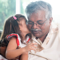 Indian-grandpa-kiss-cheek-toddler-girl