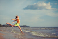 joyful-girl-leaping-on-beach