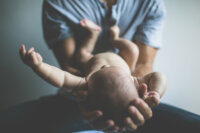 dad-holding-baby-cupped-hands